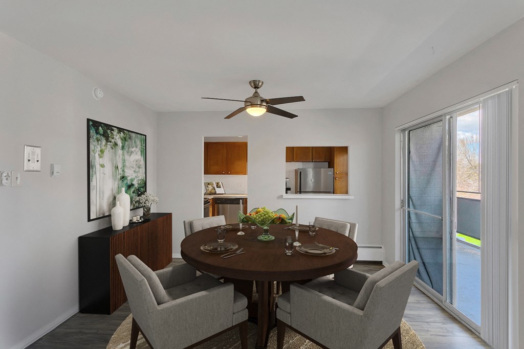 a dining room with a table and chairs and a ceiling fan