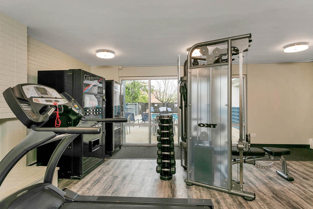 the gym in the home has a treadmill and a large screen tv