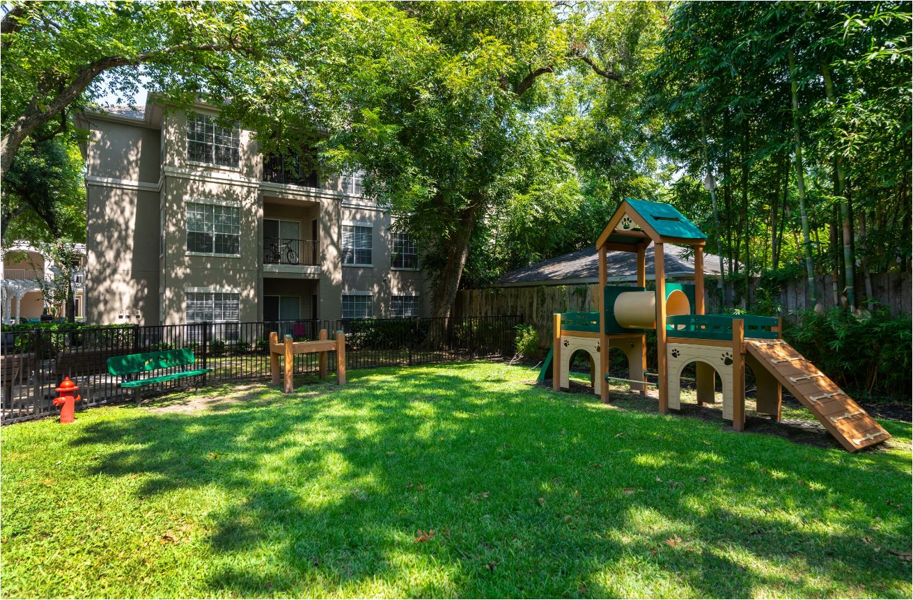 a backyard with a playground and a swing set