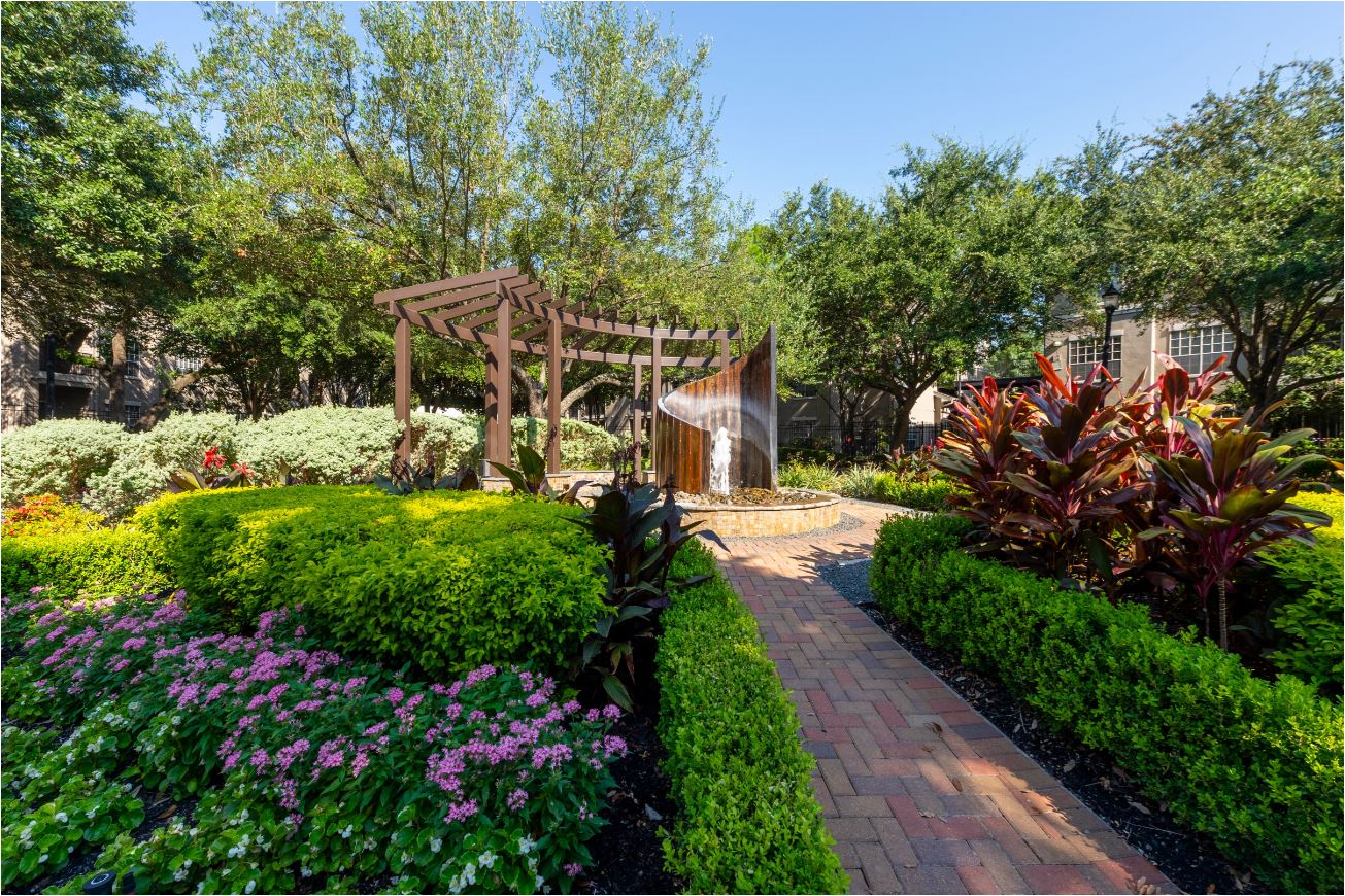 a garden with a walkway and a wooden structure