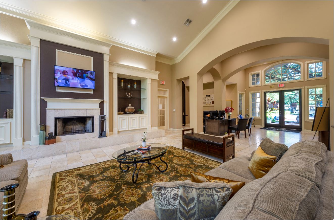 a large living room with a couch and a fireplace