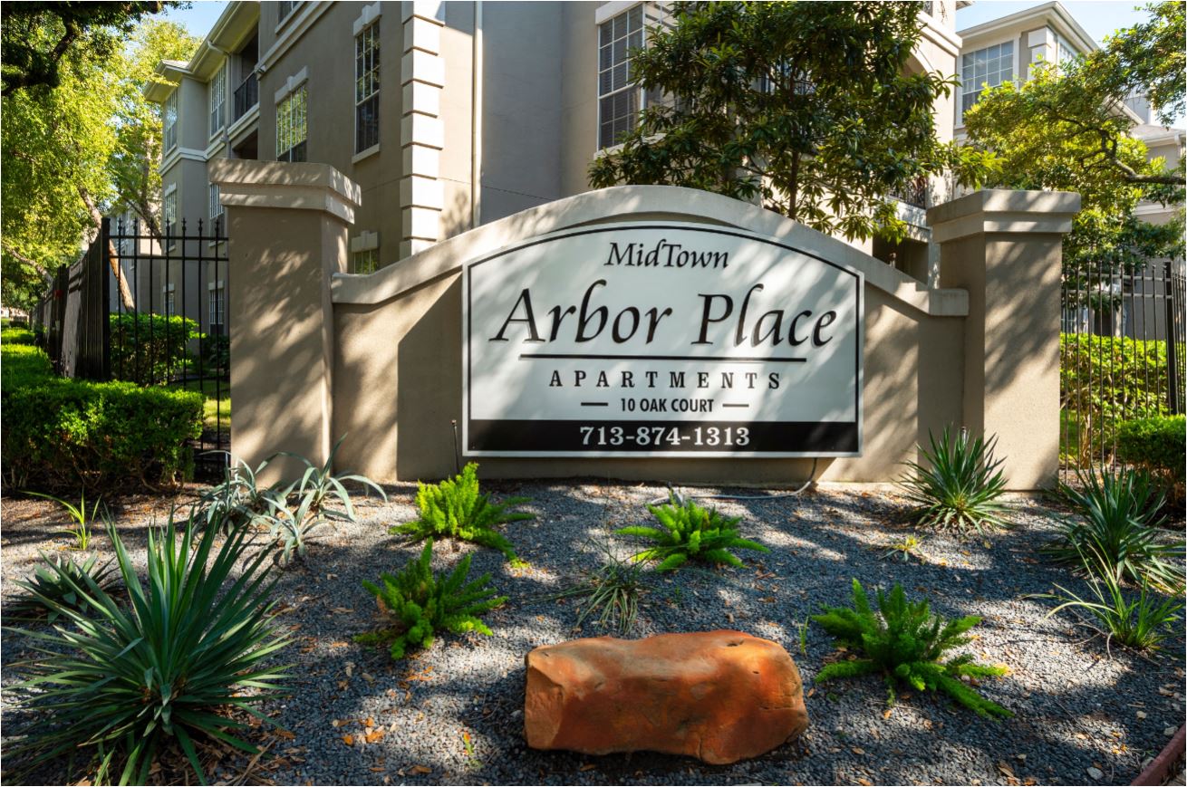 an arbor place apartments sign in front of a building