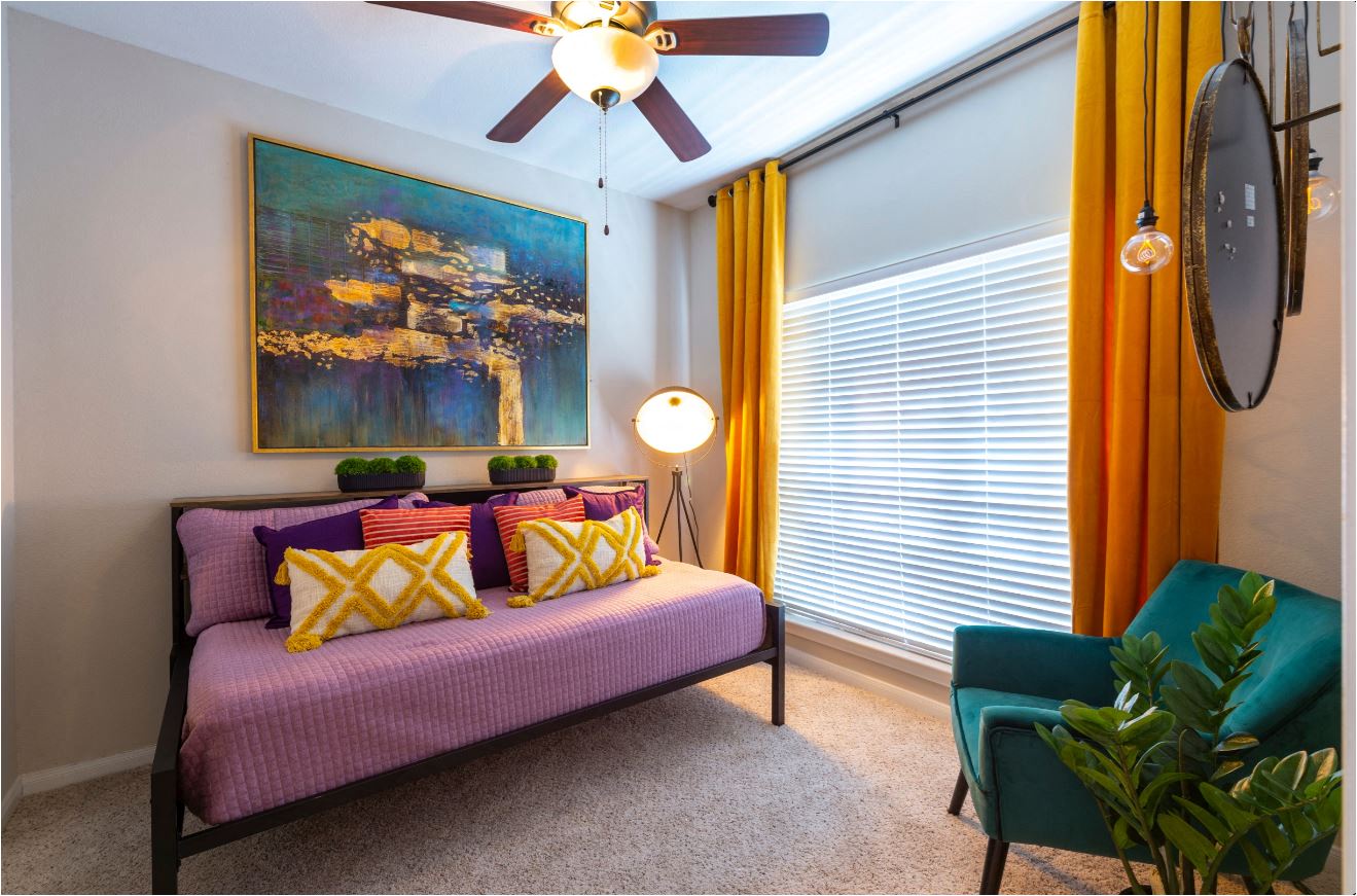 a living room with a couch and a ceiling fan