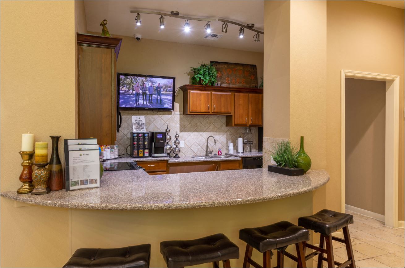 a kitchen with a bar and stools