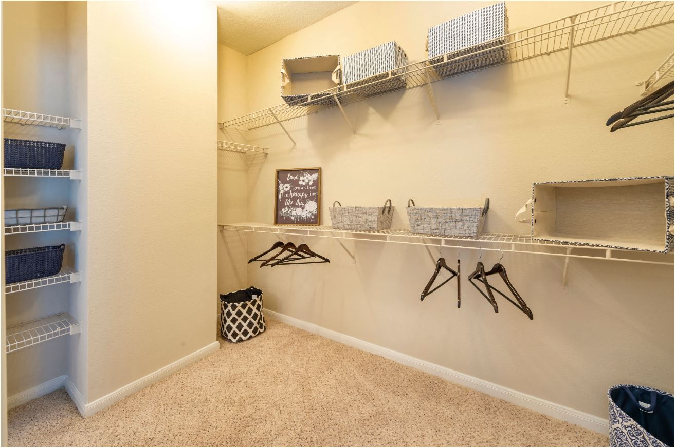 a spacious walk in closet with shelves and racks