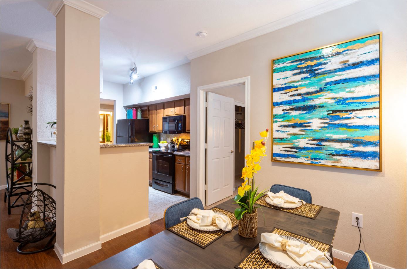 a living room and kitchen with a table and chairs