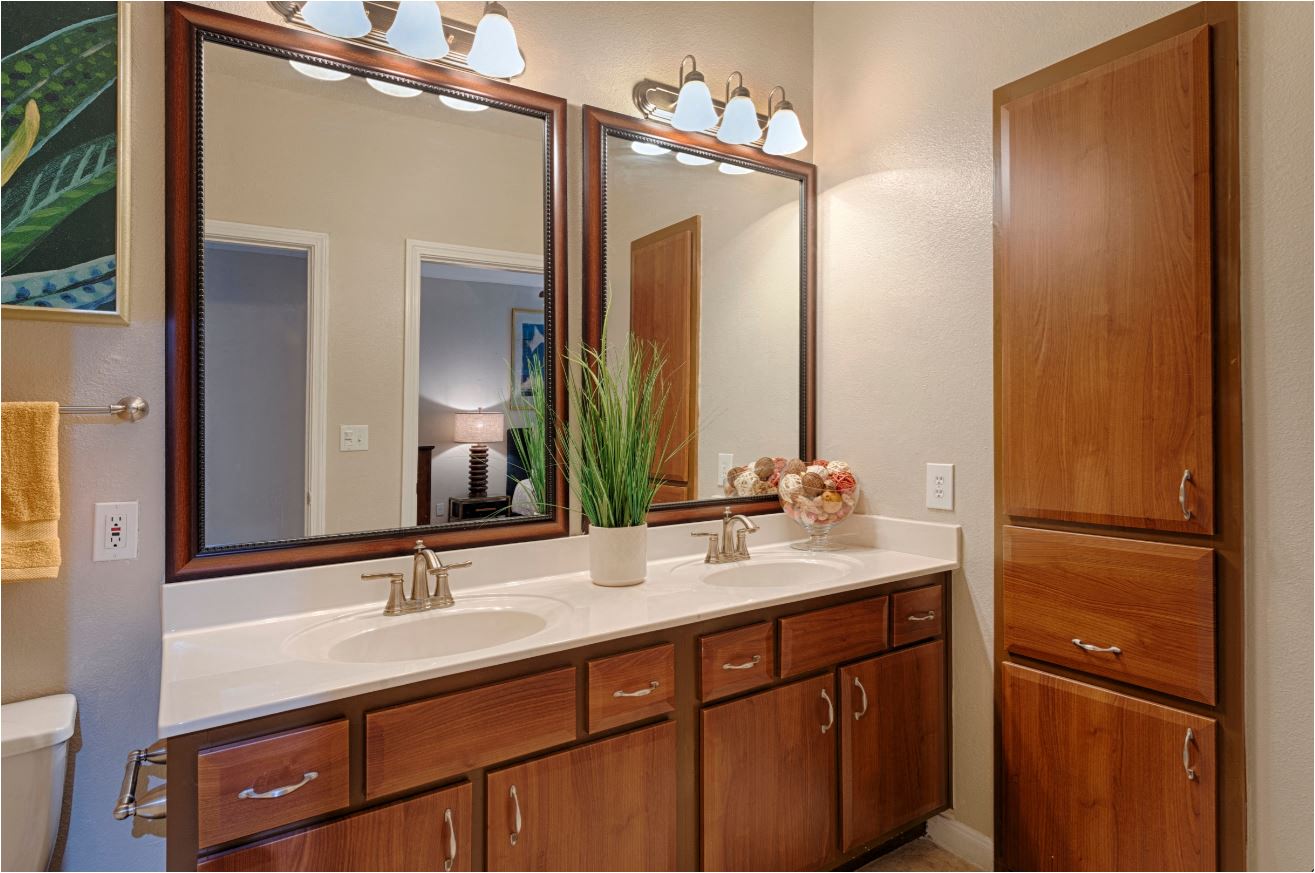 a bathroom with two sinks and a large mirror