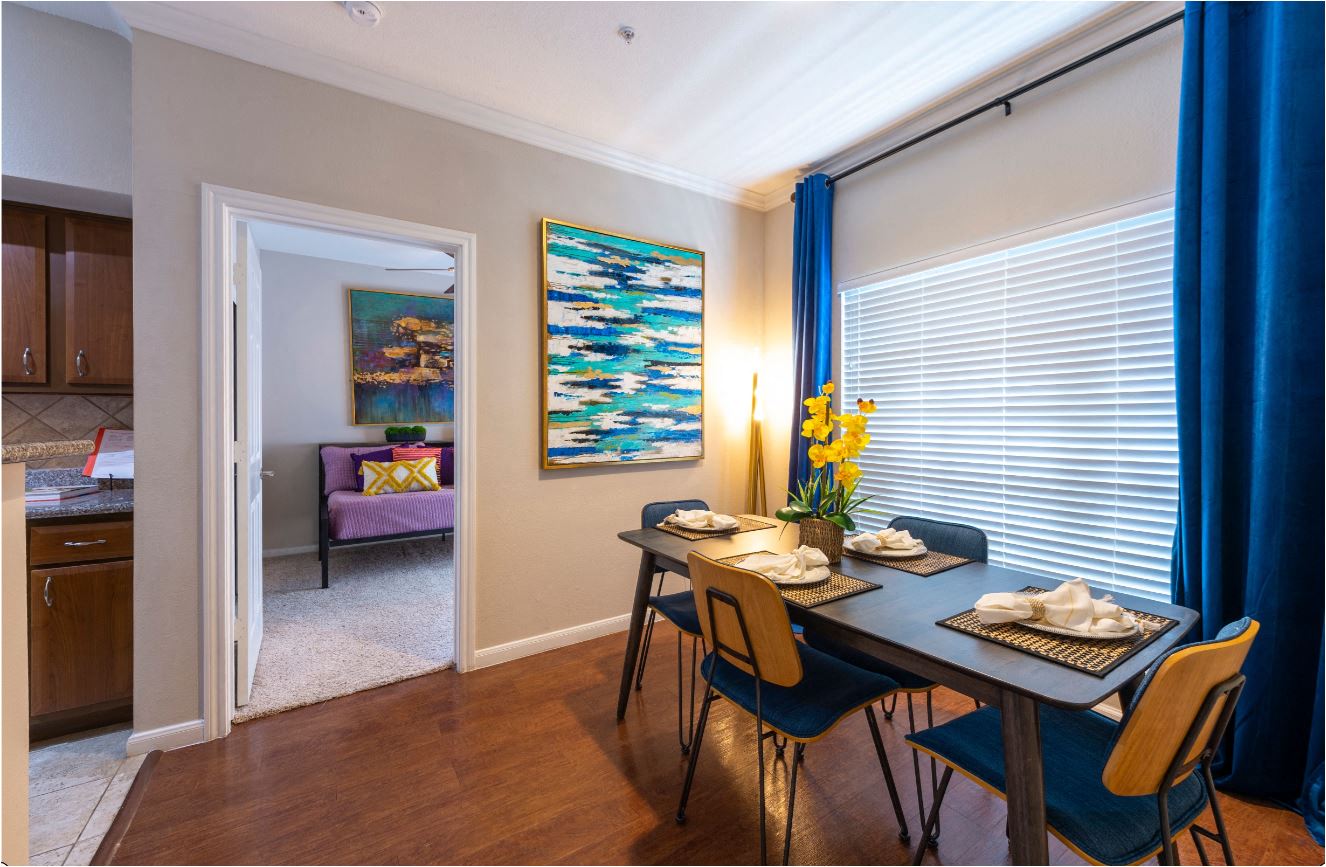a dining room with a table and chairs and a window
