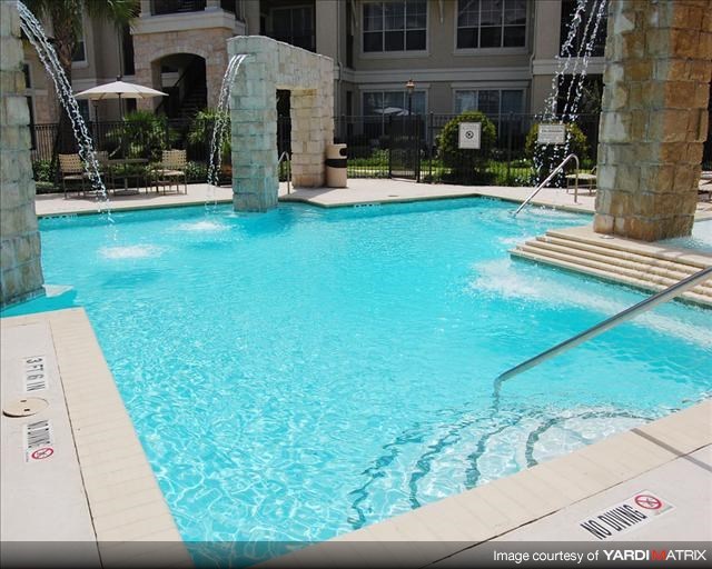 a large swimming pool with a water fountain