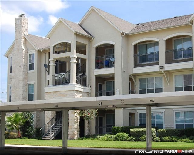 a large house with a balcony and a fence