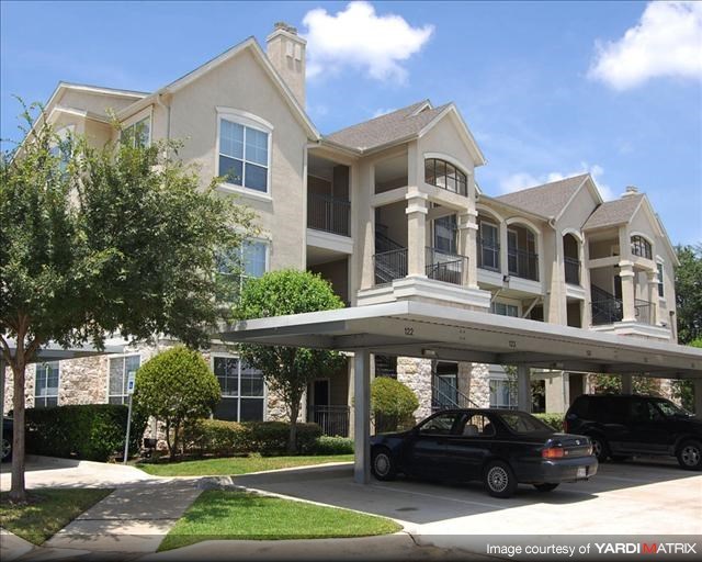 a large house with cars parked in front of it
