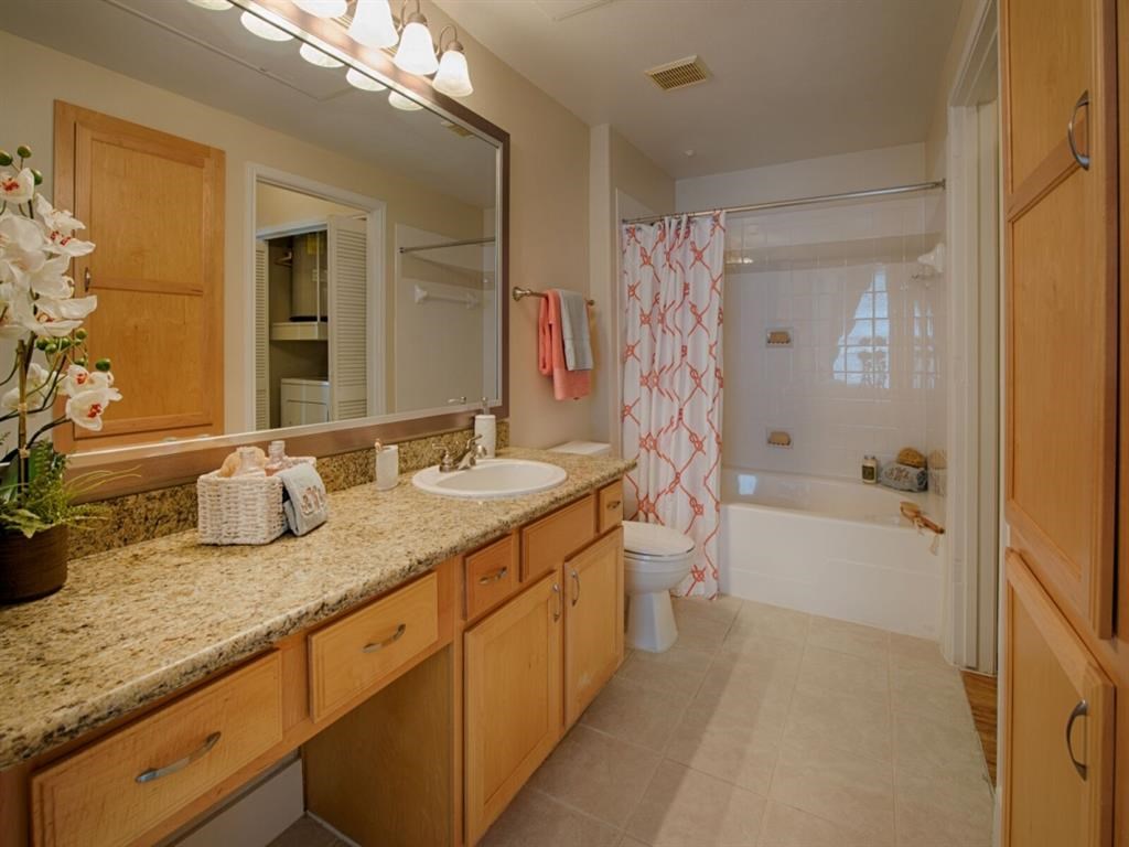 a bathroom with a sink and a toilet and a shower