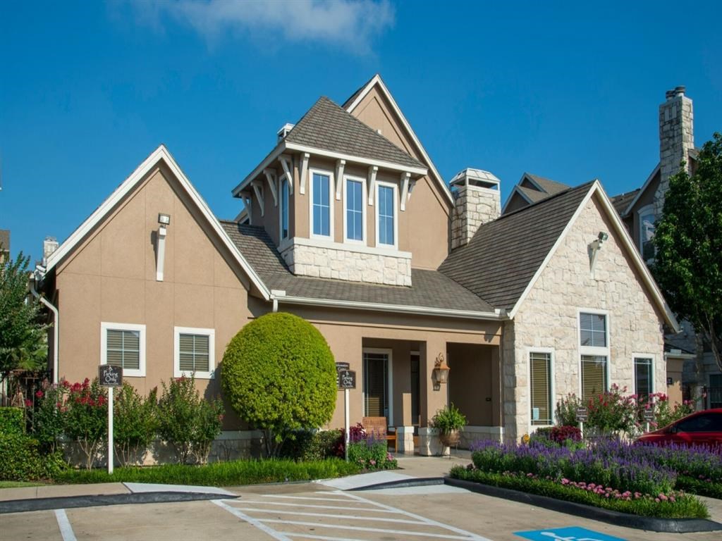 a large house with a parking lot in front of it