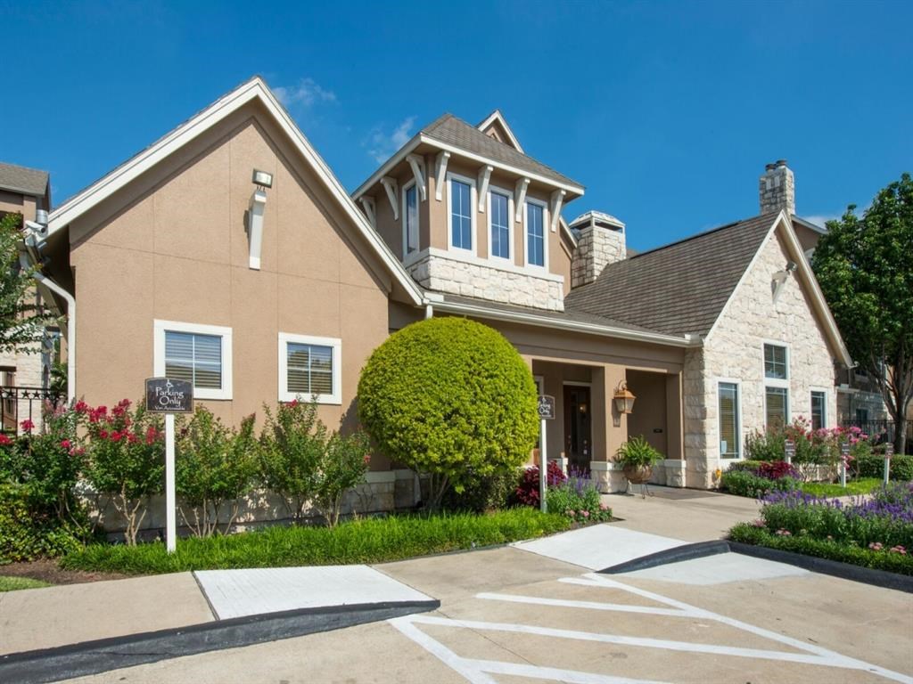 the front of a house with a yard and a driveway