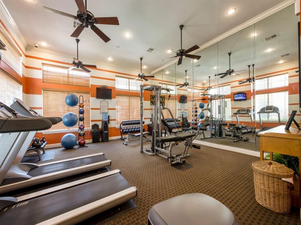 a gym with treadmills and other exercise equipment in a home gym