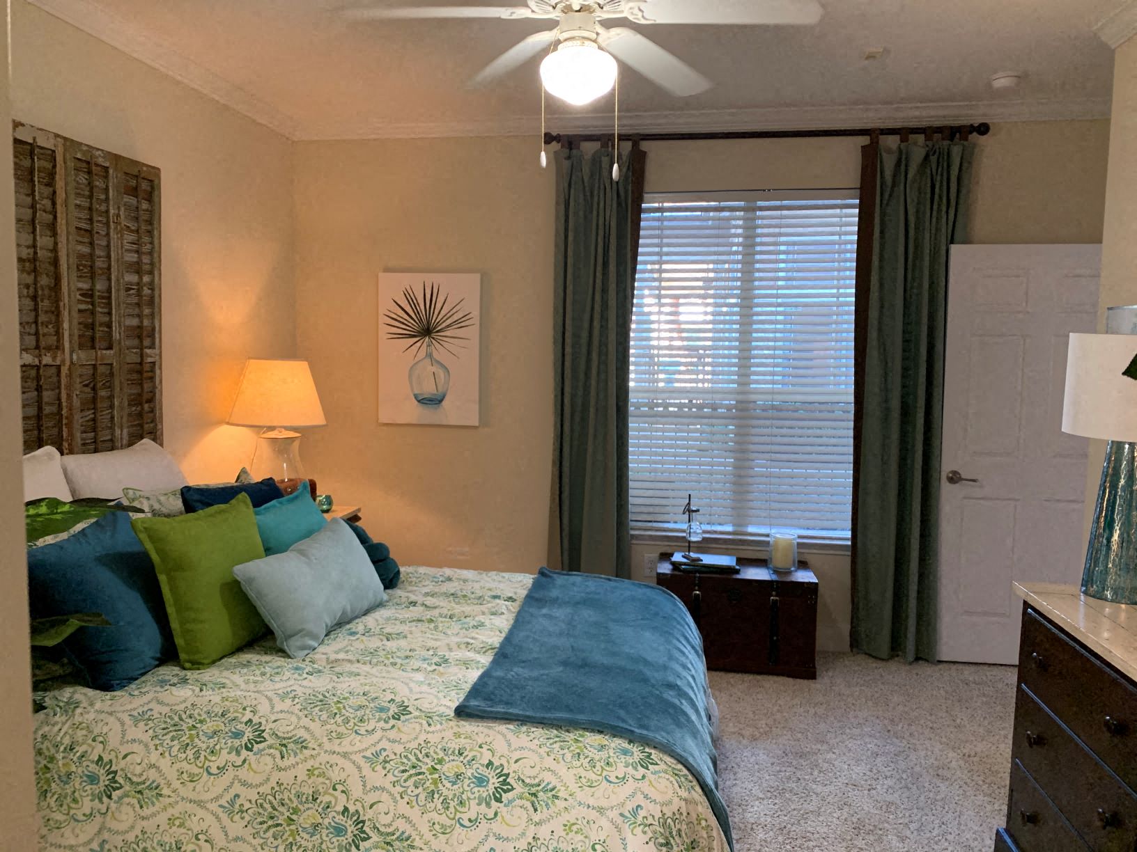 a bedroom with a bed and a ceiling fan