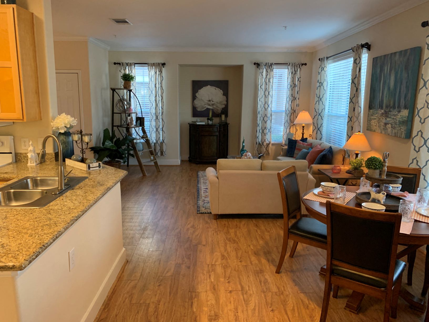 a view of a living room and dining room from the kitchen