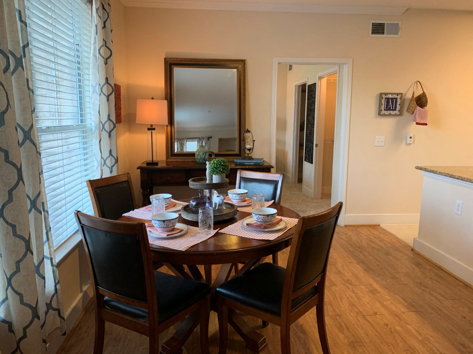 a dining room with a wooden table and chairs