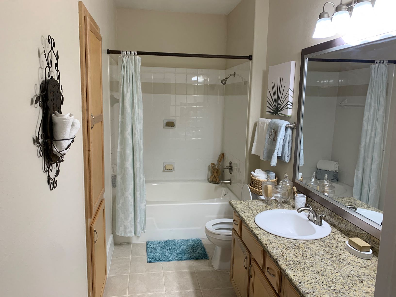a bathroom with a sink and a toilet and a shower