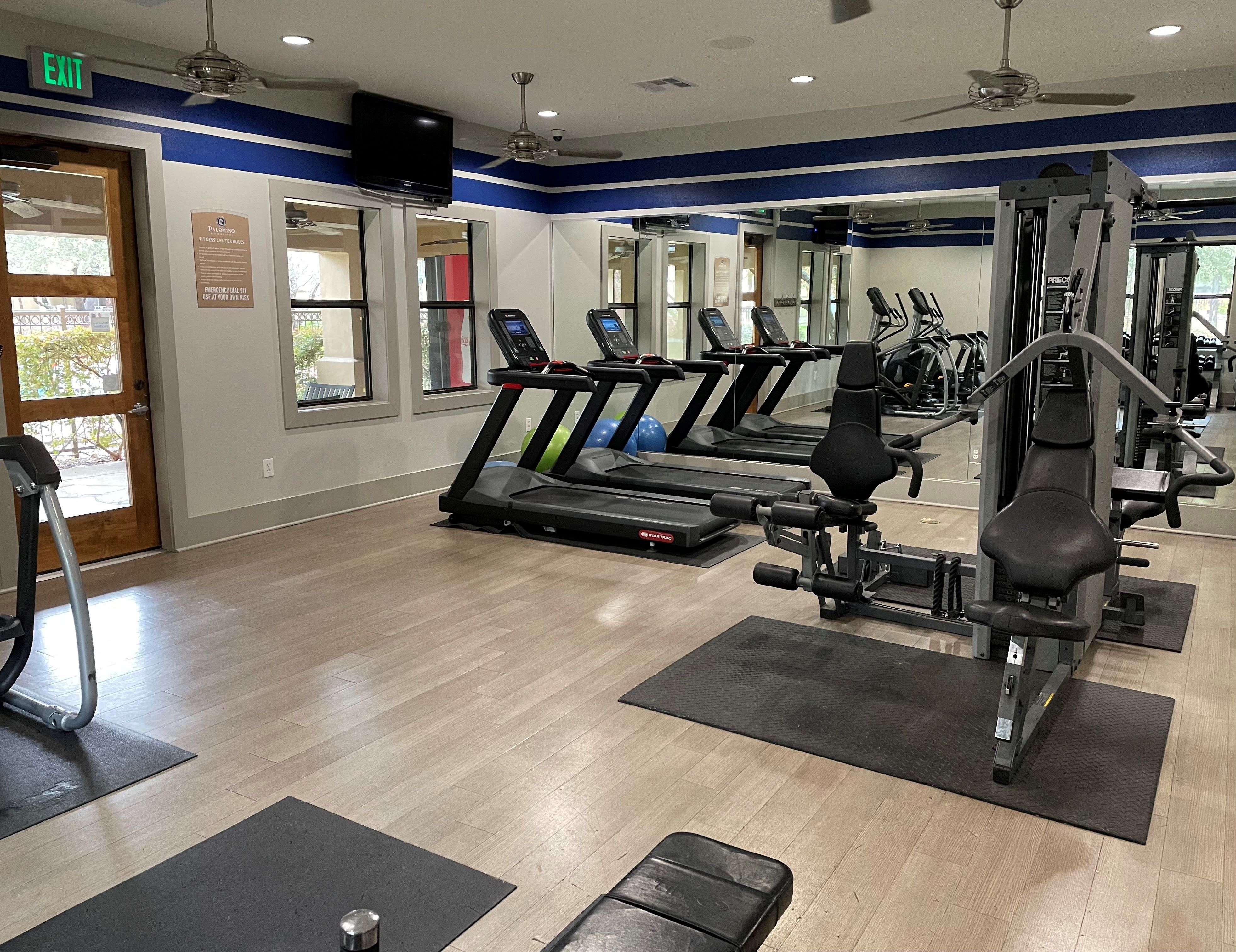 a gym with treadmills and other exercise equipment
