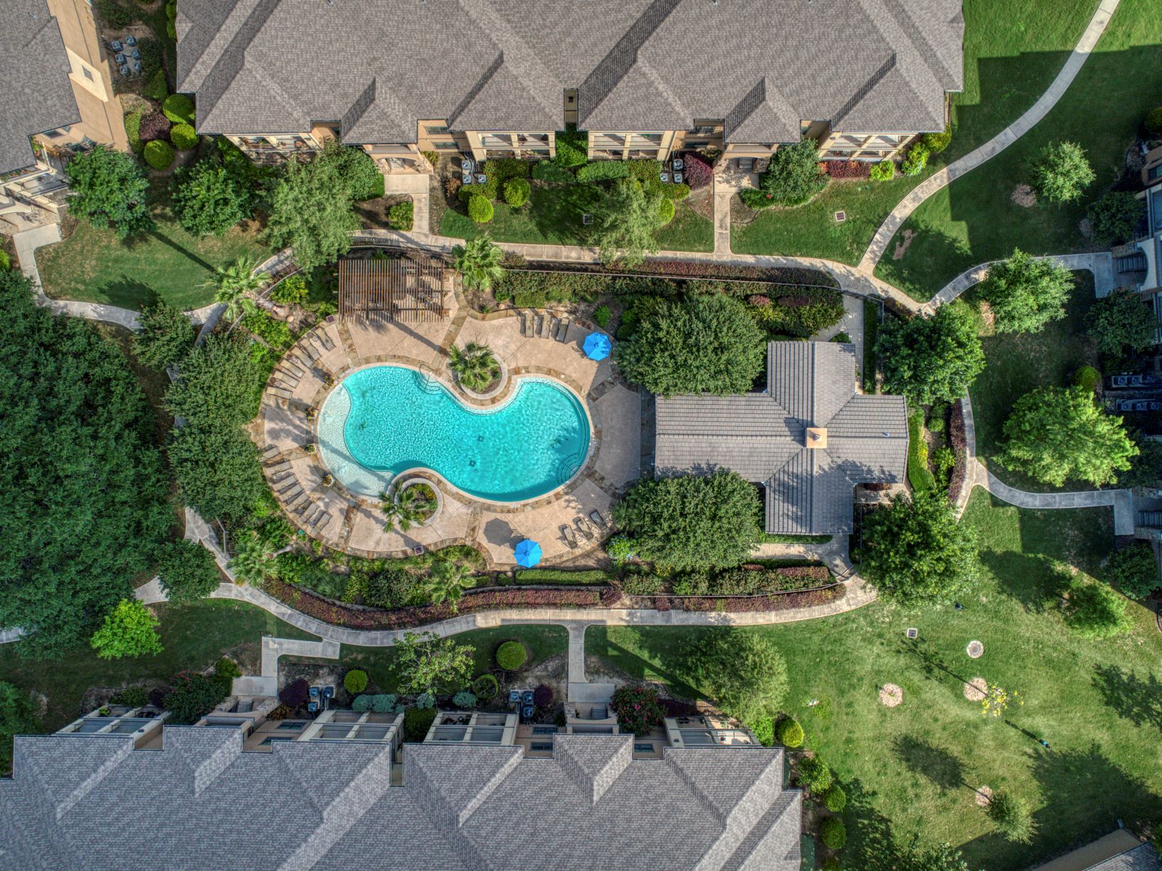 an overhead view of a swimming pool in the backyard of a house