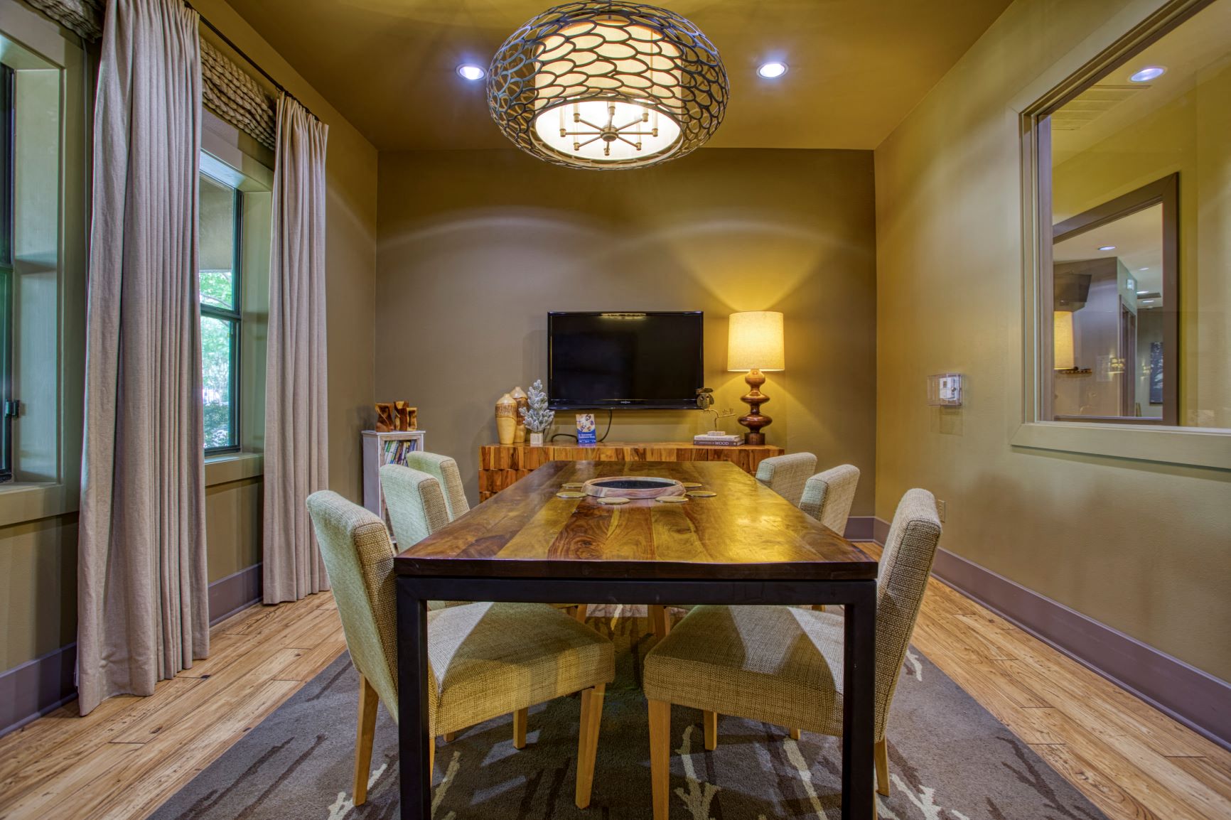 a dining room with a table and chairs and a television