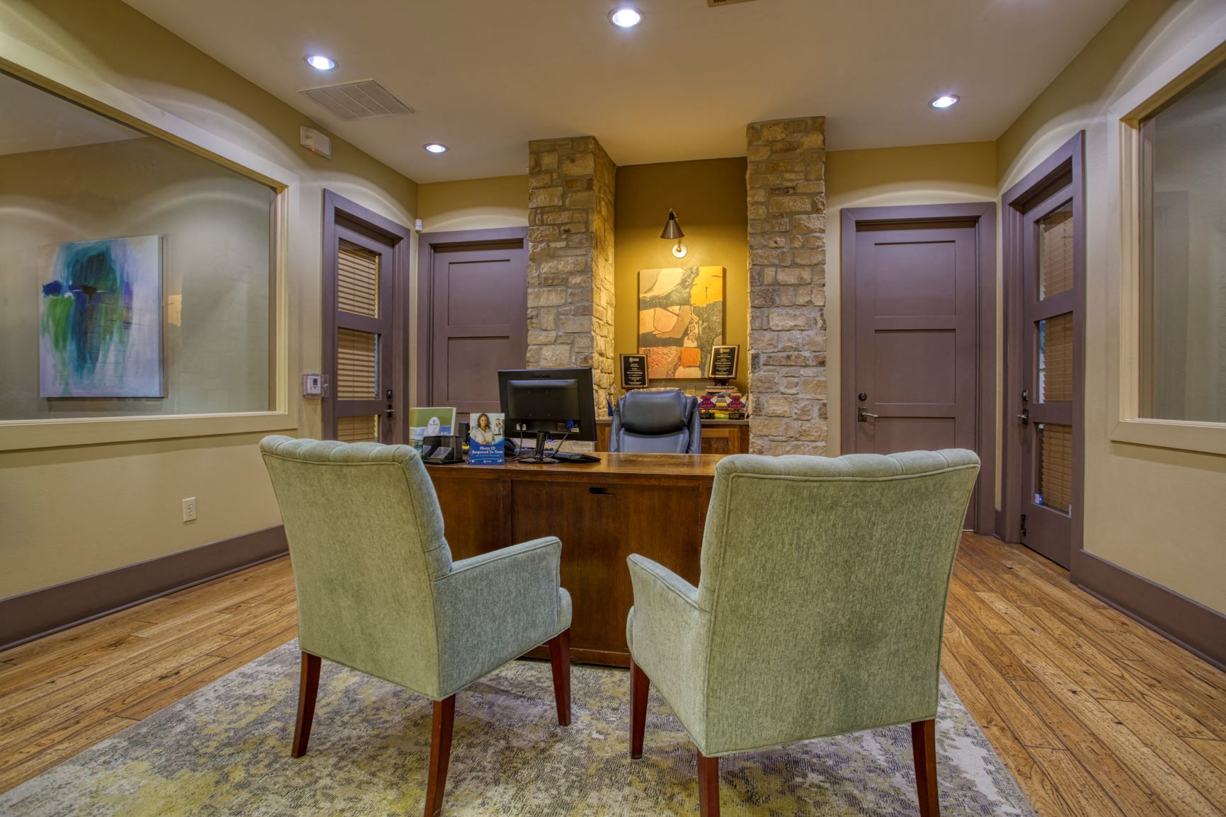 a home office with a desk and two chairs