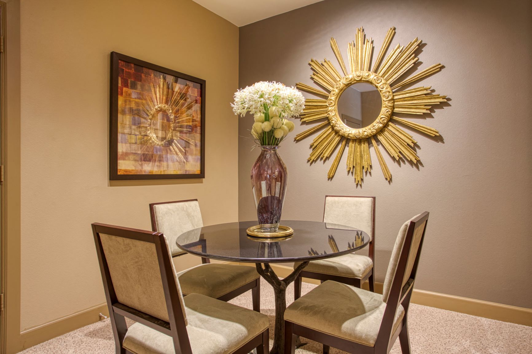 a dining room with a table and chairs and a mirror