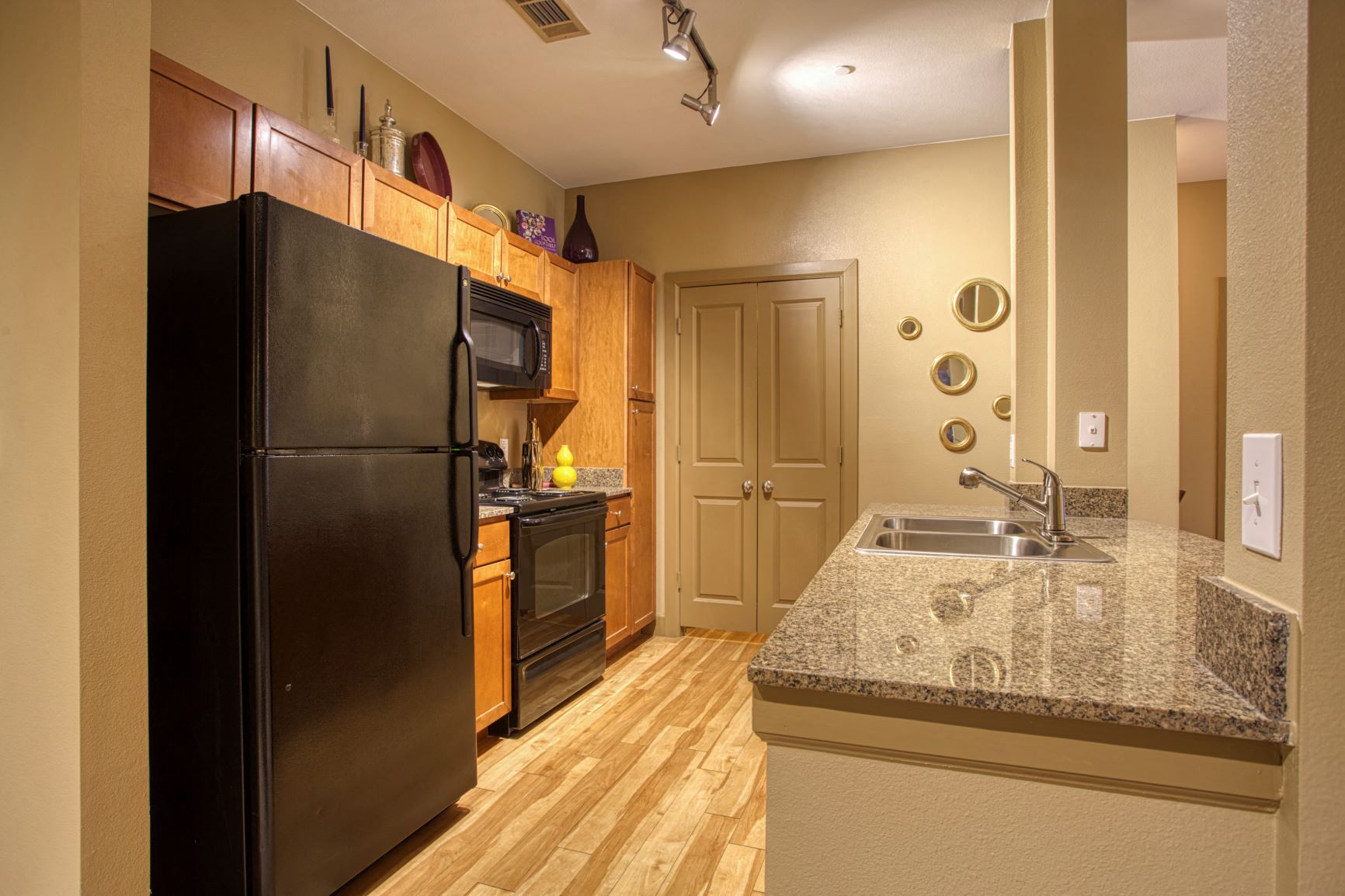 a kitchen with a granite counter top and a black refrigerator