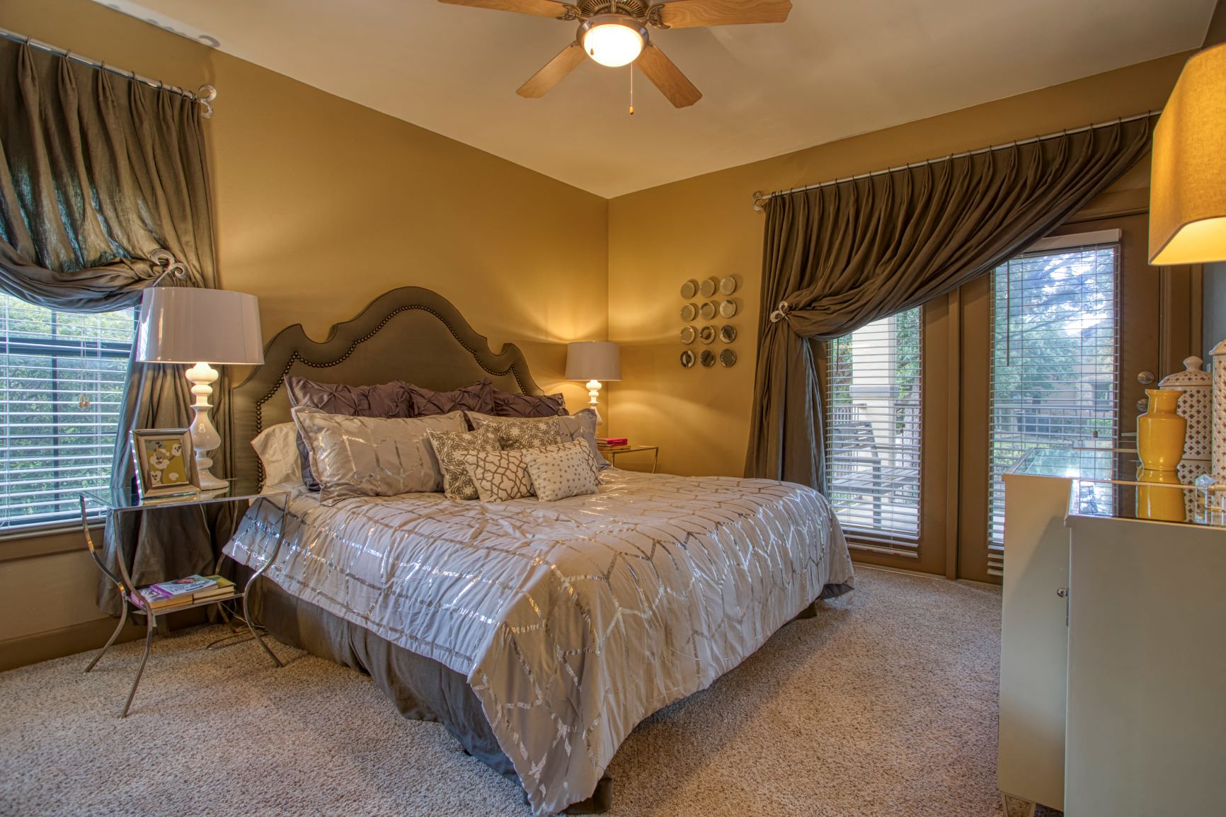 a bedroom with a bed and a ceiling fan