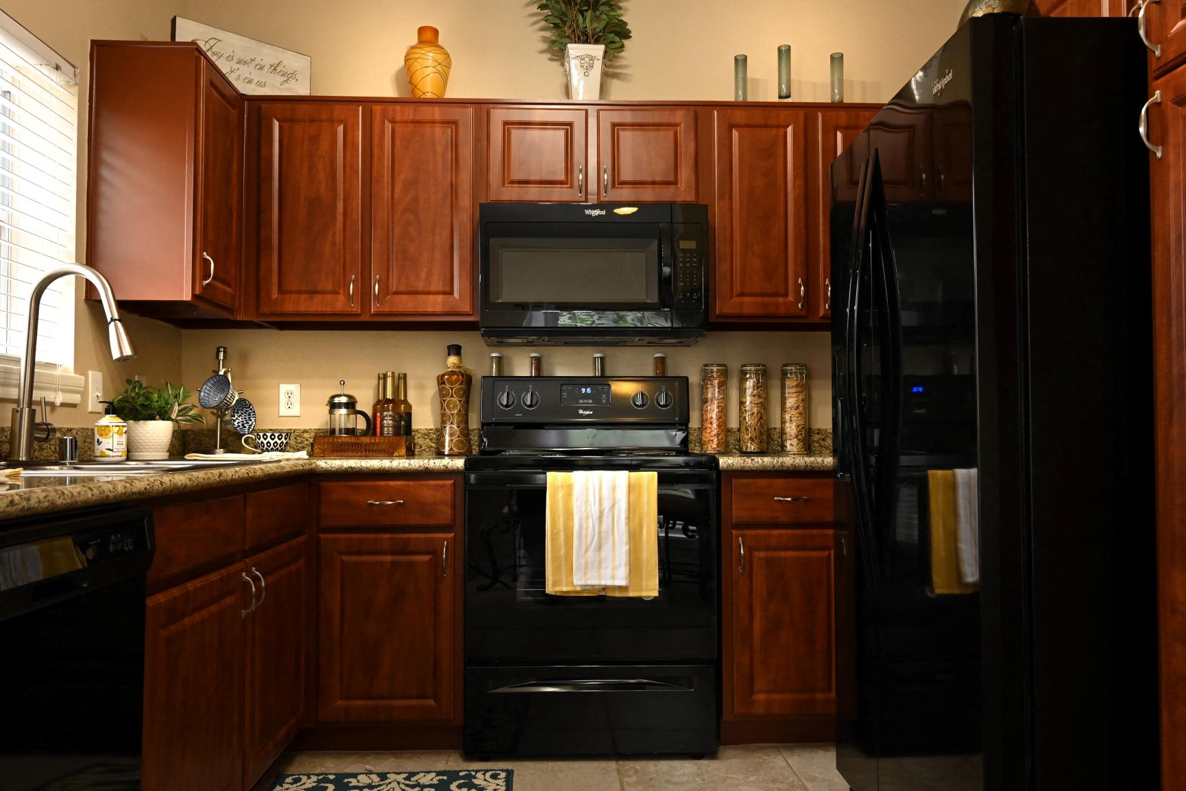 a kitchen with black appliances and wooden cabinets