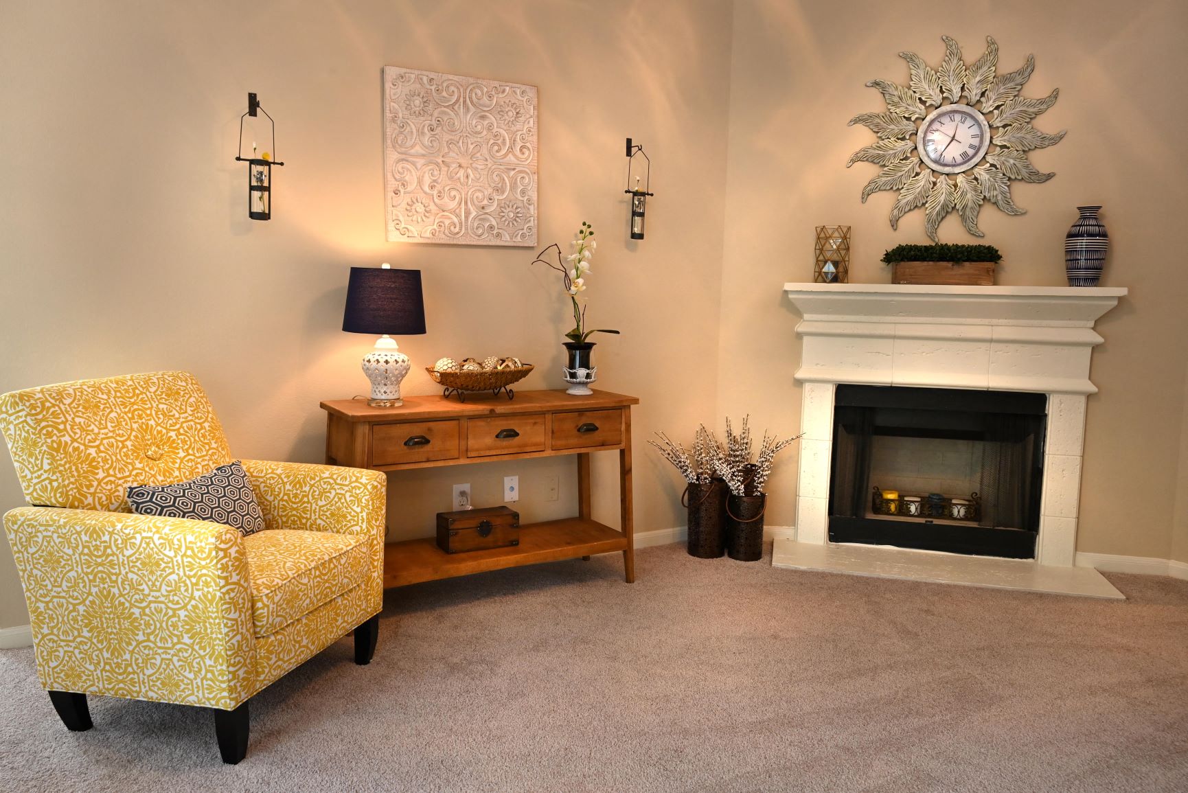 a living room with a fireplace and a yellow chair