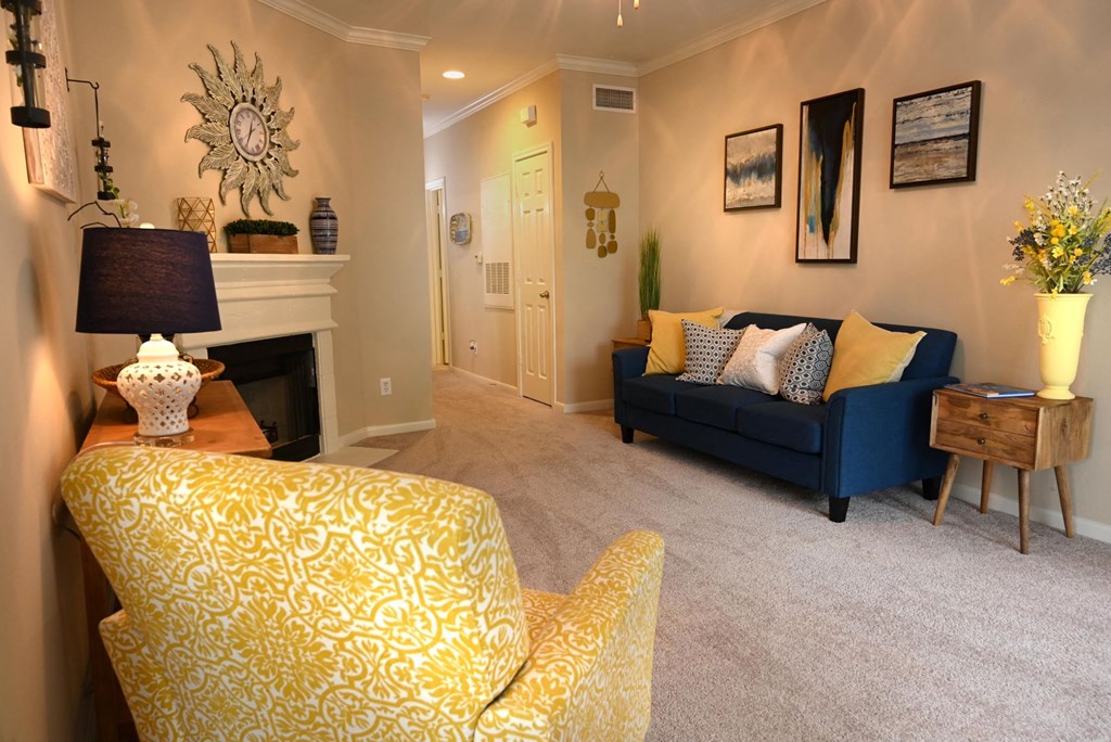 a living room with a couch and a chair and a fireplace