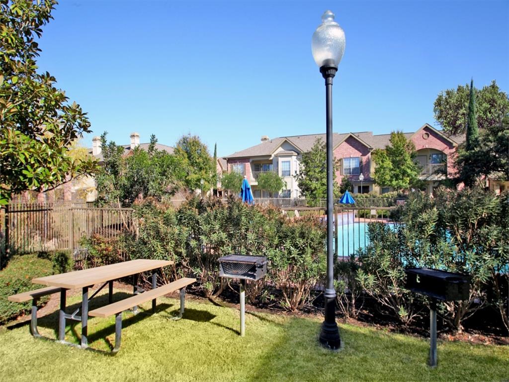 a backyard with a picnic table and a lamp post