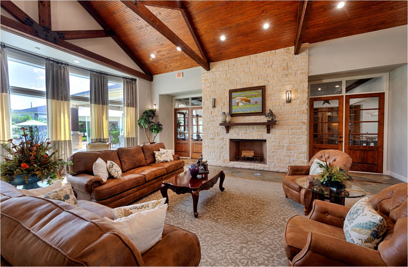 a large living room with couches and a fireplace