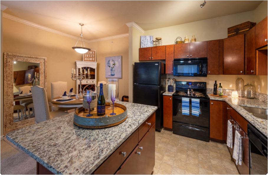 a kitchen with black appliances and granite counter tops