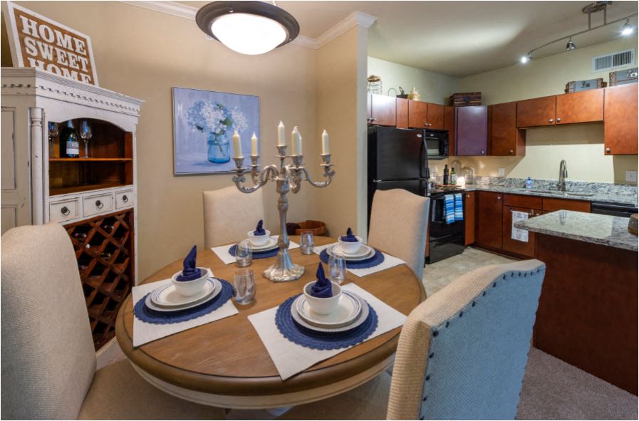 a dining room with a table and chairs and a kitchen