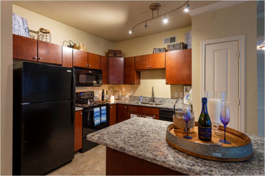 a kitchen with black appliances and granite counter tops