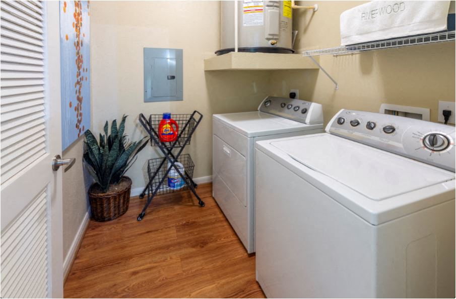 a laundry room with two washes and a dryer