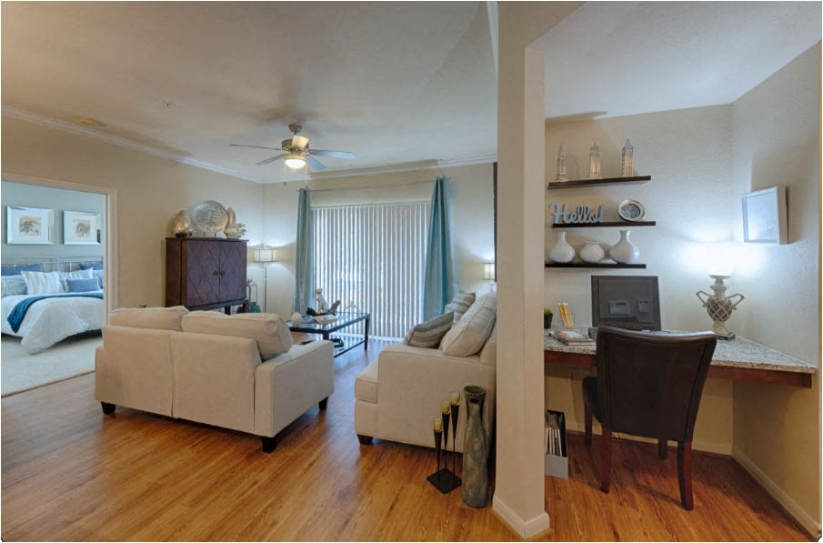 a living room with a couch and a desk
