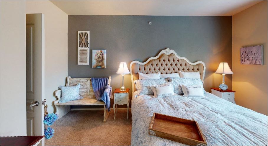 a bedroom with a bed and a chair