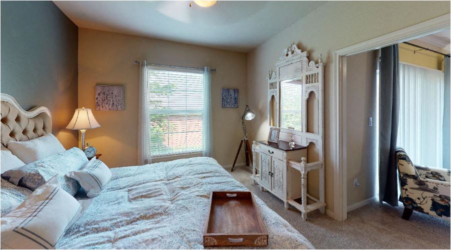 a bedroom with a large bed and a dresser