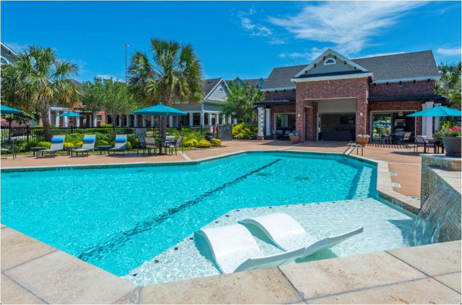 a swimming pool with a house in the background