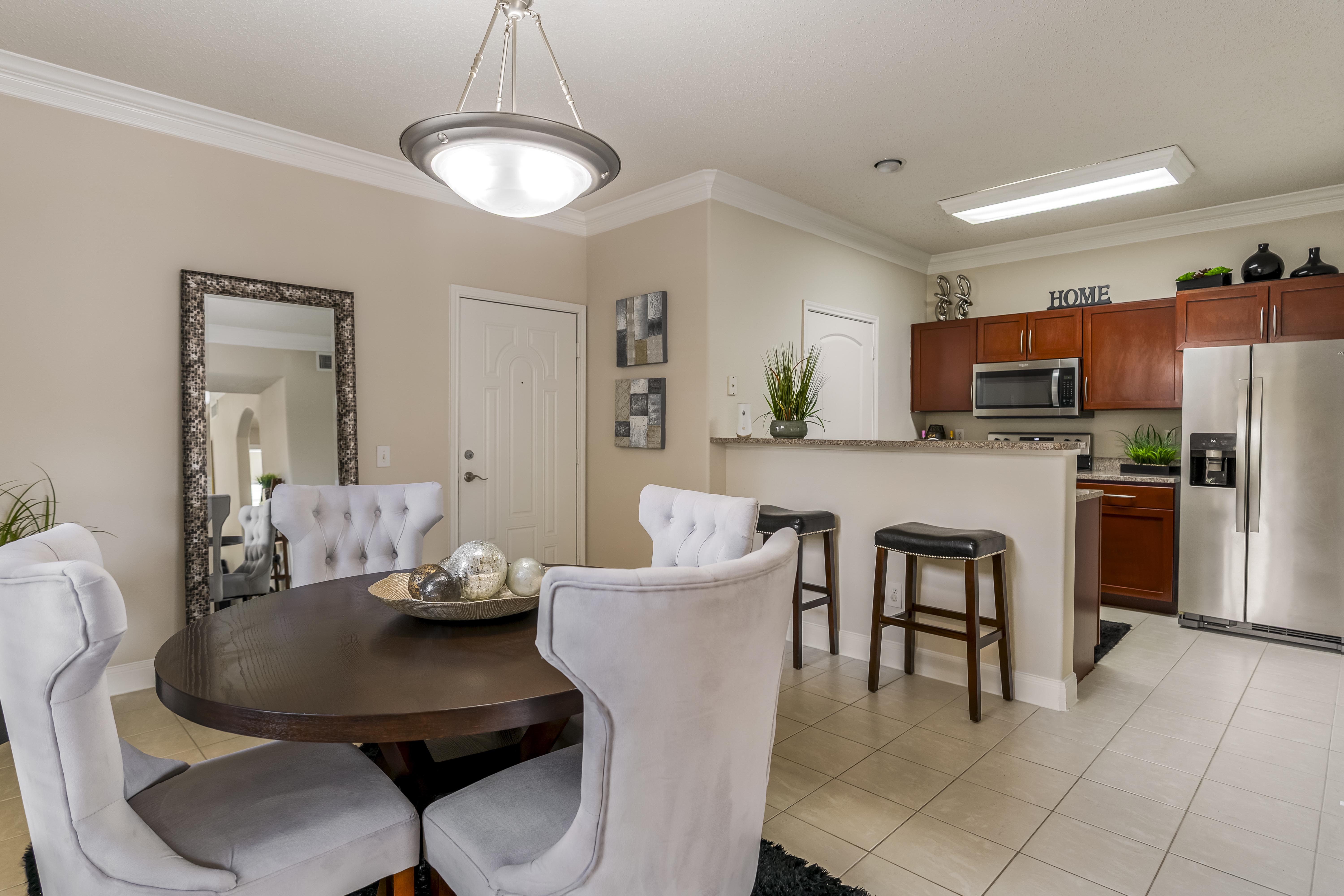 A modern dining room with a round table and chairs.