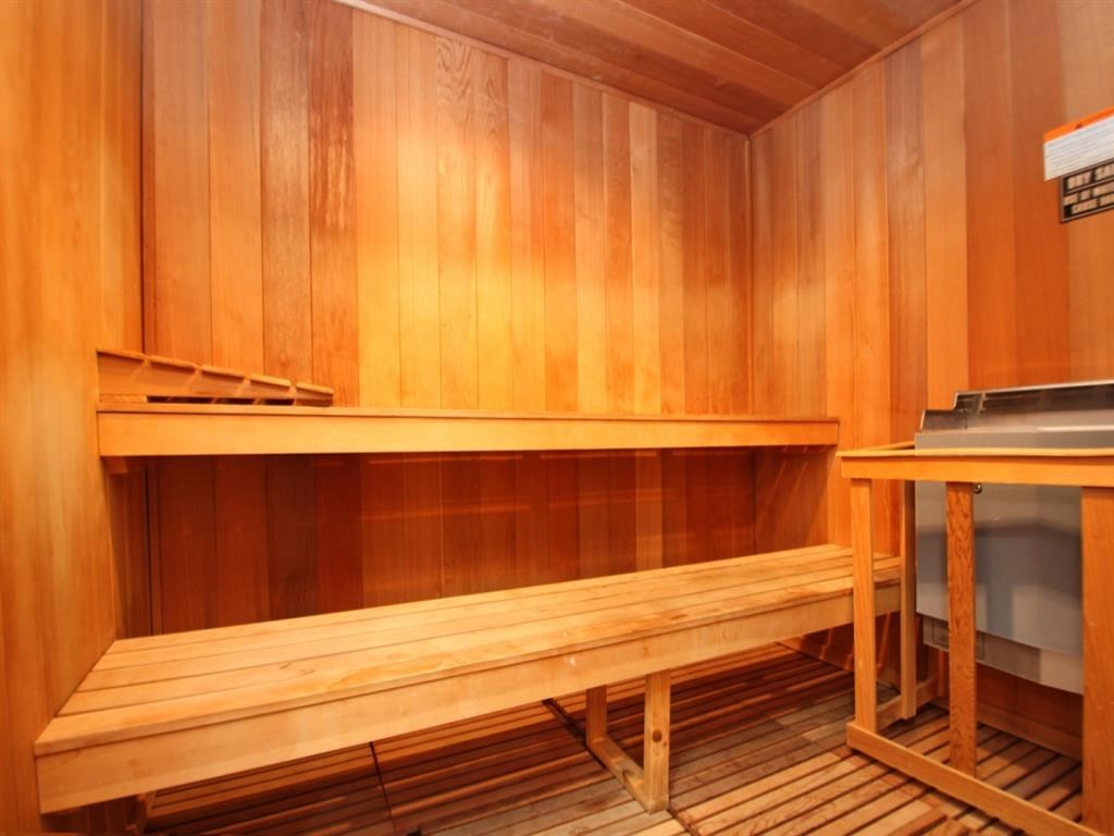 a sauna with wooden benches and a table