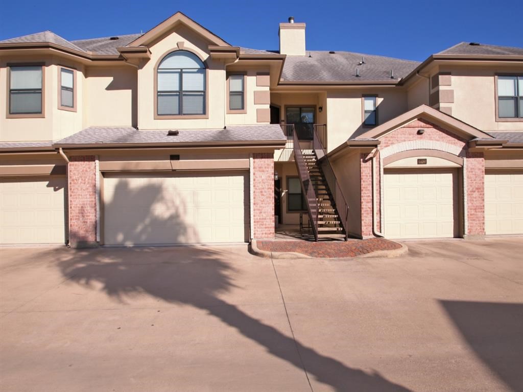 a large house with a driveway and a garage door
