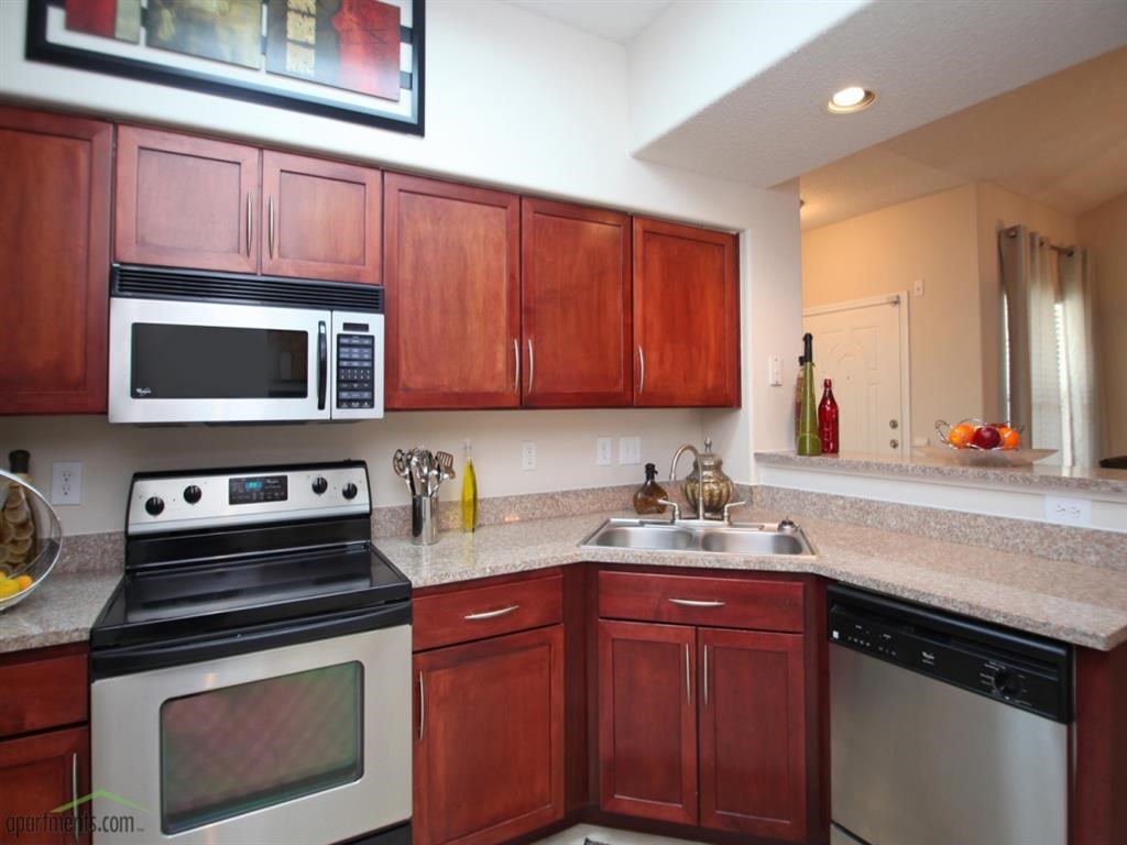 a kitchen with a stove microwave and sink