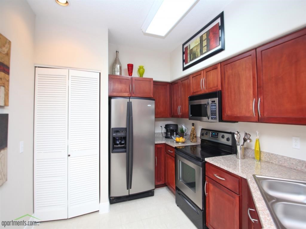a kitchen with stainless steel appliances and wooden cabinets