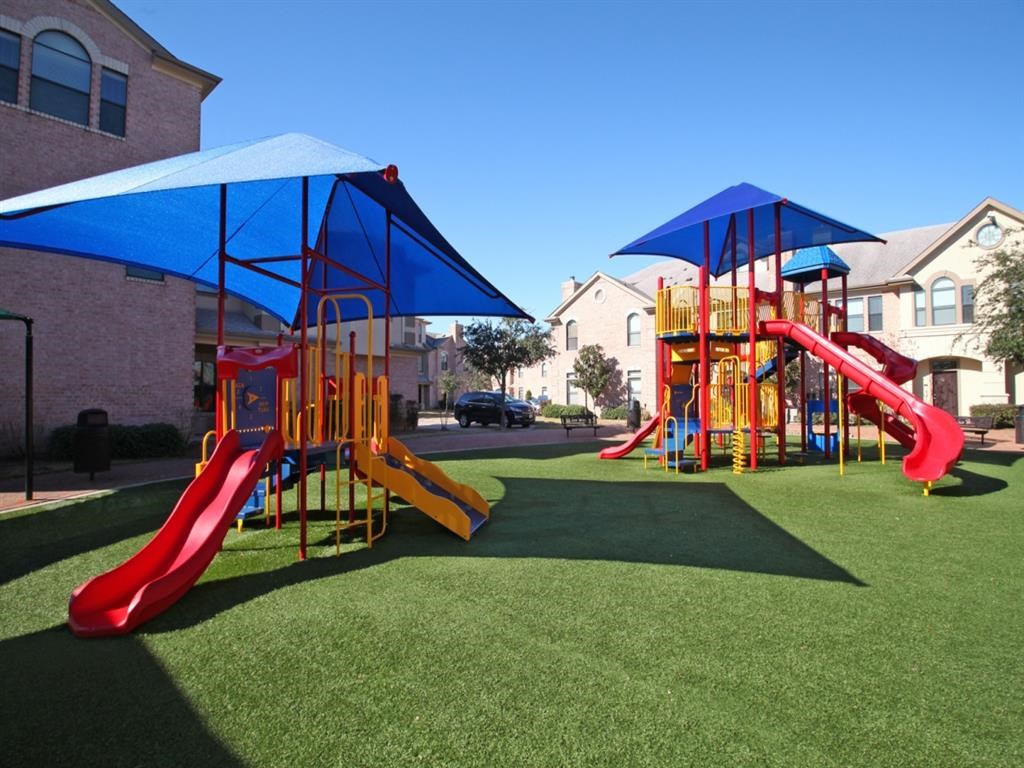 a playground with a blue and red swing set
