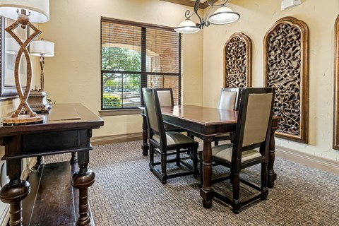 A dining room with a table and chairs.